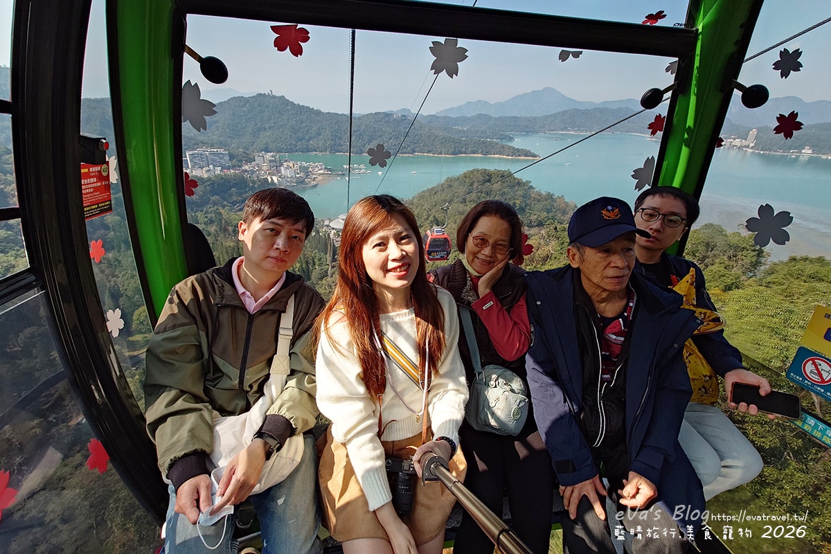 一家人在纜車上合影，背景為日月潭